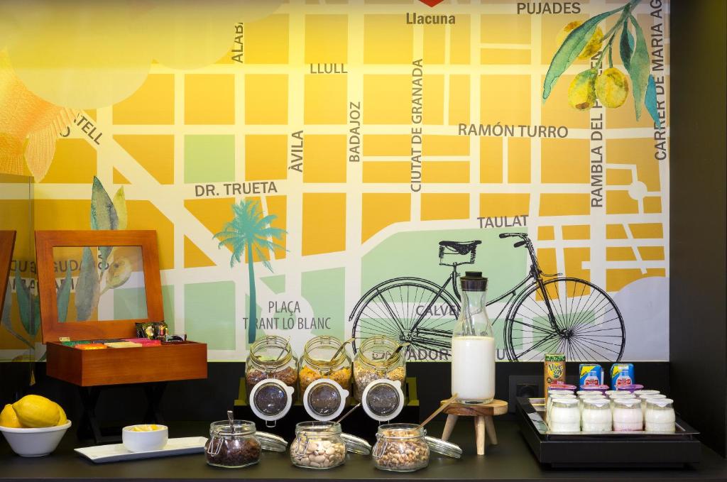 a table with a bike on a wall at Citadines Ramblas Barcelona in Barcelona