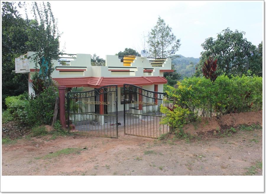 a building with a gate in front of it at Lahari Welcomes You in Madikeri