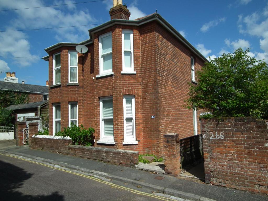 a red brick building with white windows on a street at 20 Bellevue Road in Ryde
