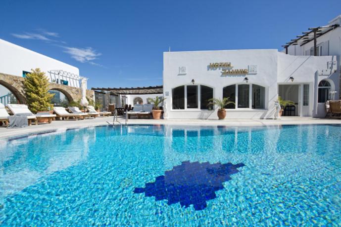 a large pool with blue water in front of a building at Zannis Hotel in M&yacute;konos City