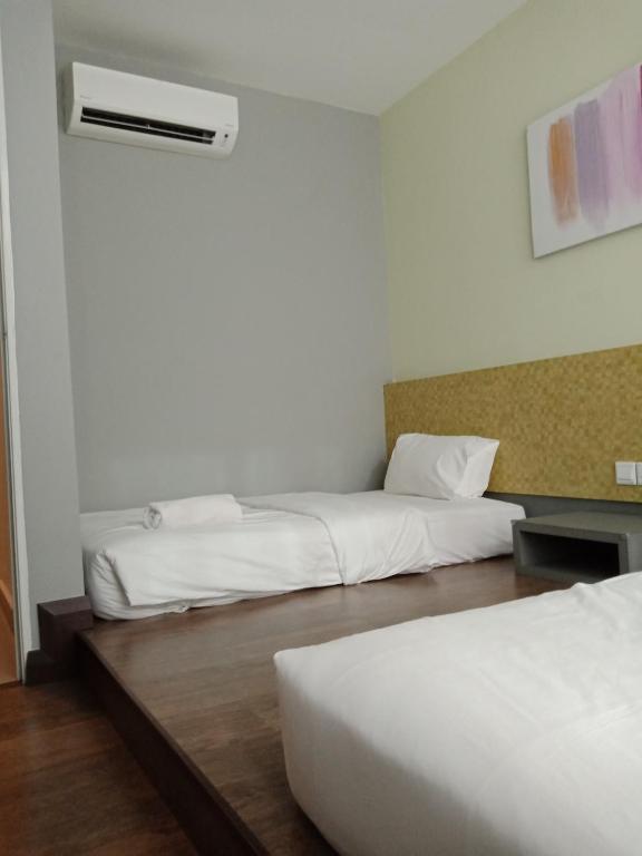 Postel nebo postele na pokoji v ubytování Lemon 8 Boutique Hotel @ Melaka