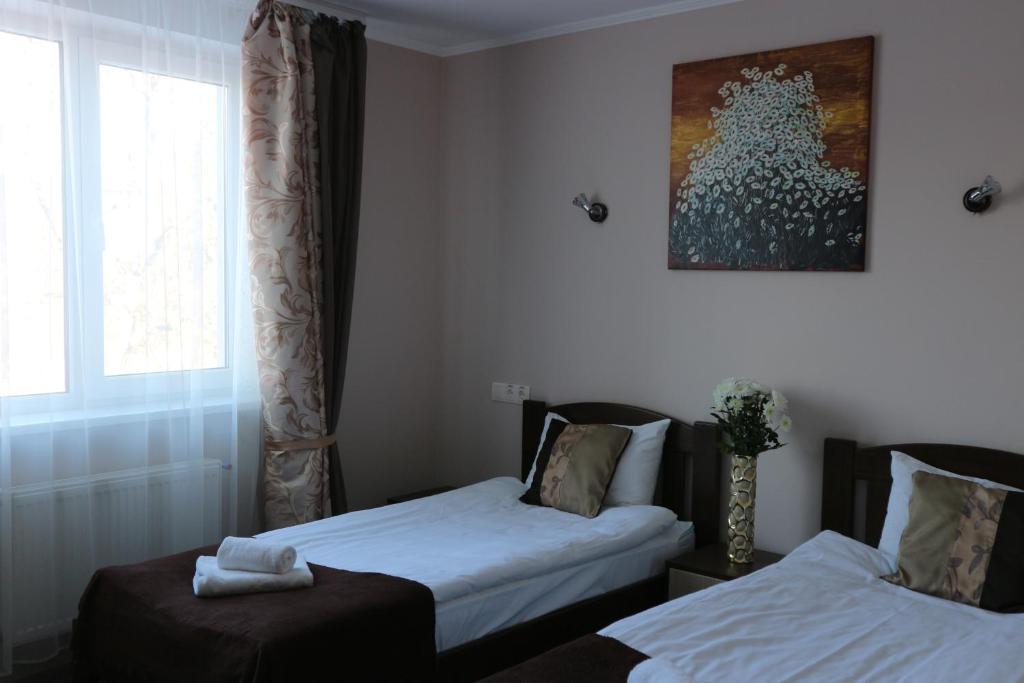Postel nebo postele na pokoji v ubytování Orange Hotel