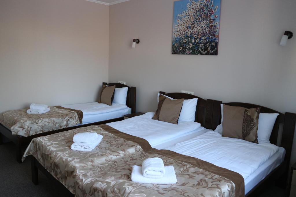 Postel nebo postele na pokoji v ubytování Orange Hotel