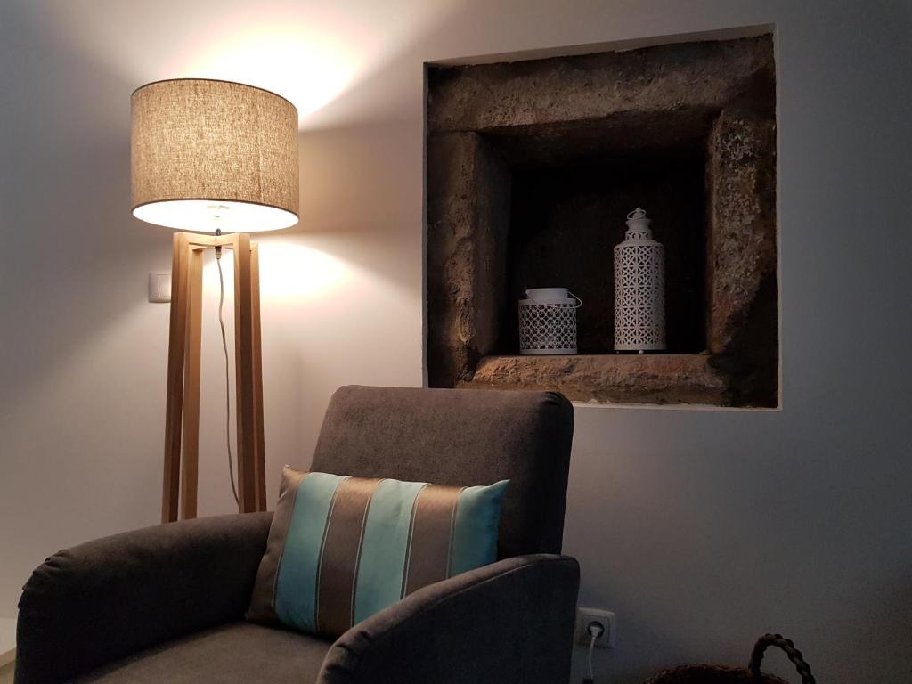a living room with a chair and a lamp at Casa Vista da Marquesa in Nordeste