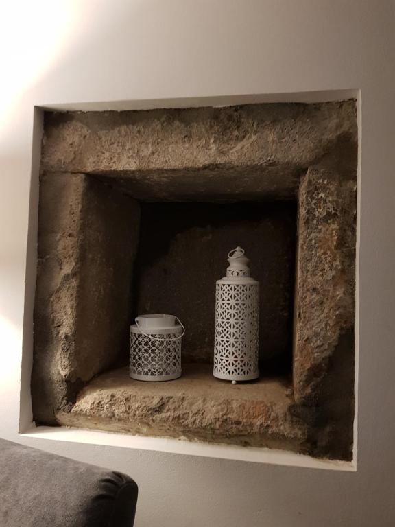 two vases are sitting in a stone fireplace at Casa Vista da Marquesa in Nordeste