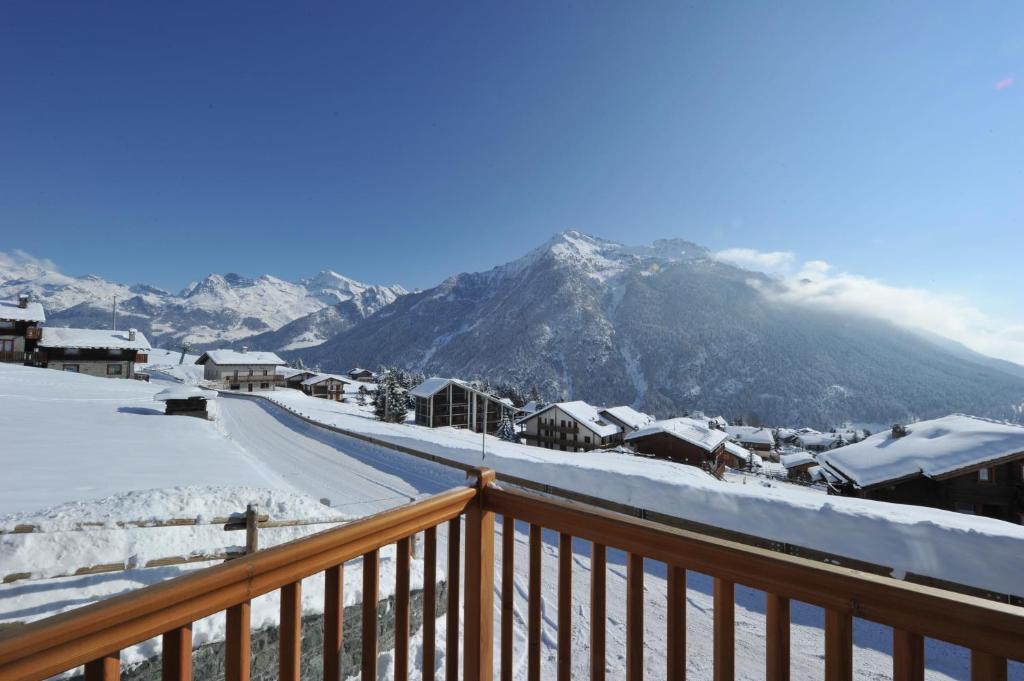 a view of a snow covered mountain from a balcony at Gresil Residence in Champoluc