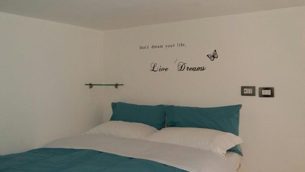 サレルノにあるCasa Vacanze EmaEleのベッドルーム1室(壁に引用符が付いたベッド1台付)