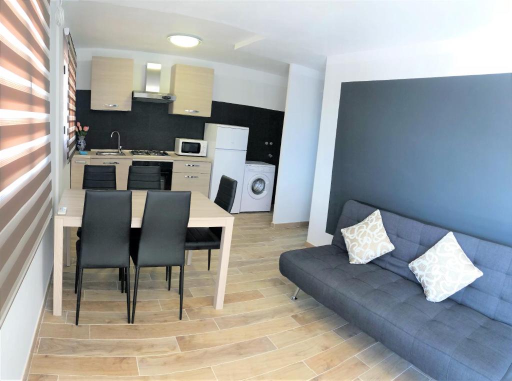 a kitchen and living room with a couch and a table at Villa hortencia in Tarragona
