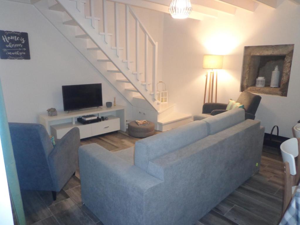 a living room with a couch and a tv at Casa Vista da Marquesa in Nordeste