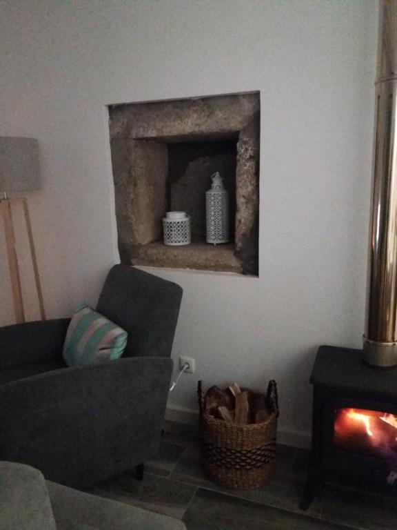 a living room with a couch and a fireplace at Casa Vista da Marquesa in Nordeste