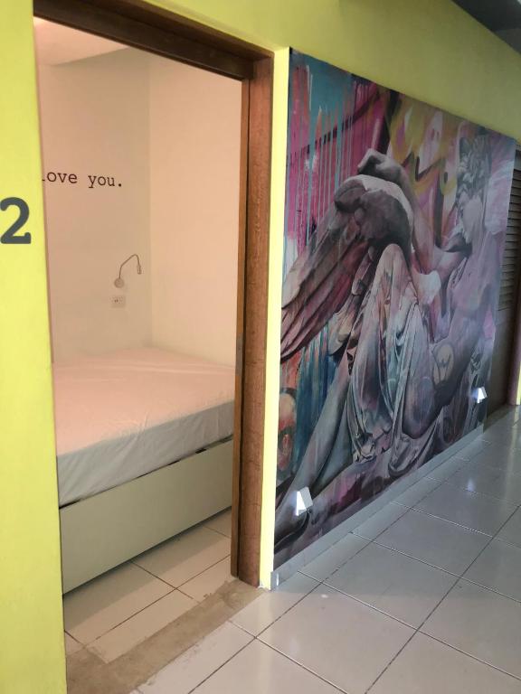 Postel nebo postele na pokoji v ubytování Hostel Frente al Mar Tropico 20º