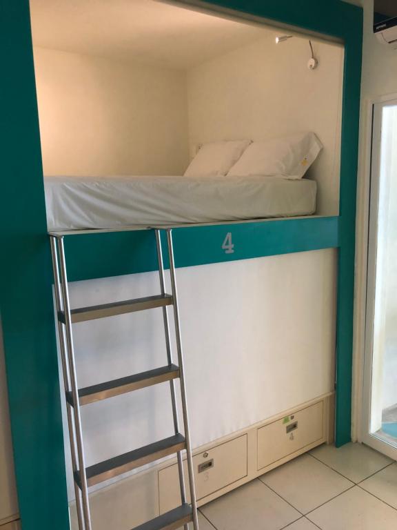 Postel nebo postele na pokoji v ubytování Hostel Frente al Mar Tropico 20º