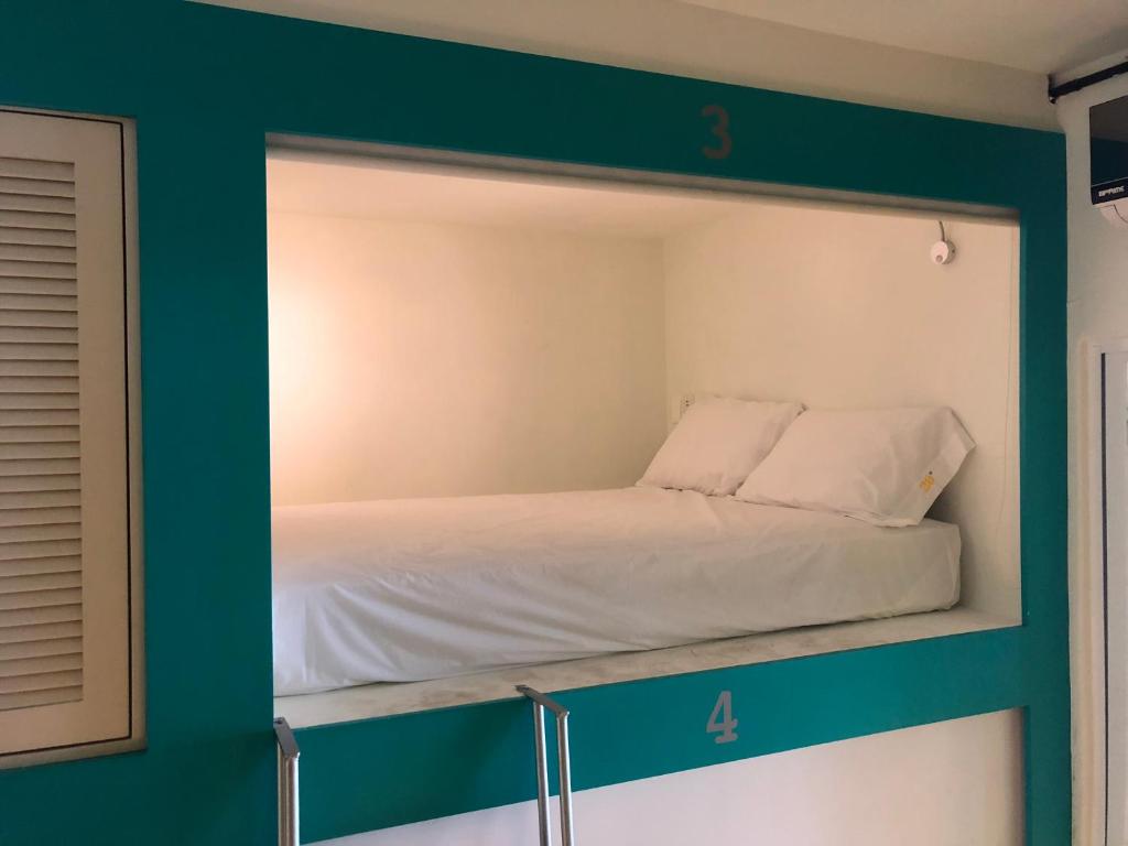 Postel nebo postele na pokoji v ubytování Hostel Frente al Mar Tropico 20º