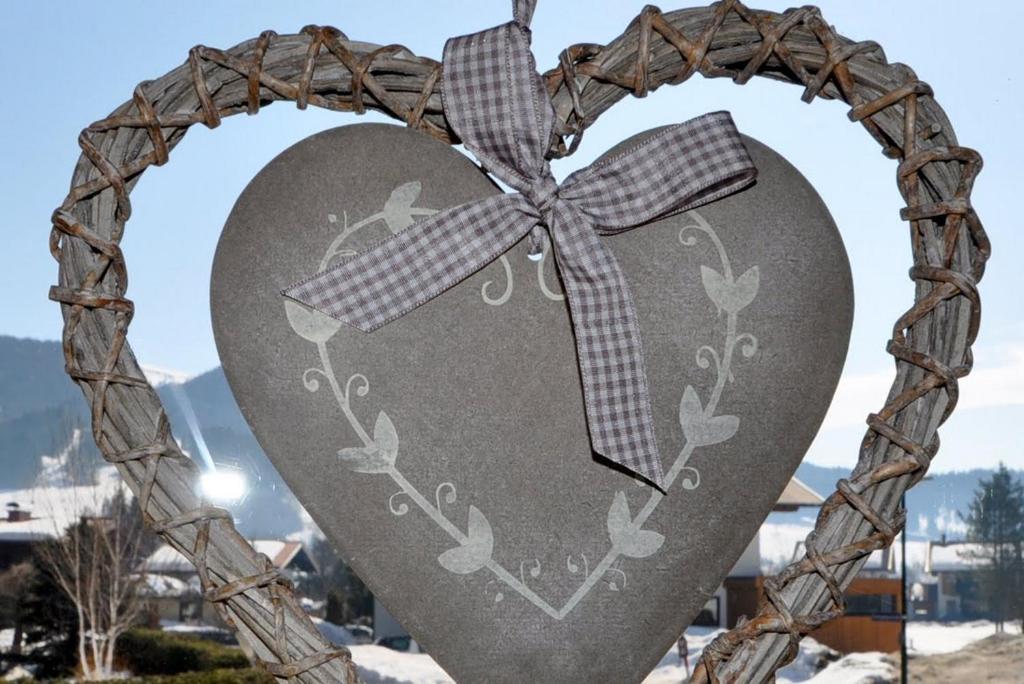 a heart shaped sign with a bow on it at Haus Treffer in Kirchdorf in Tirol