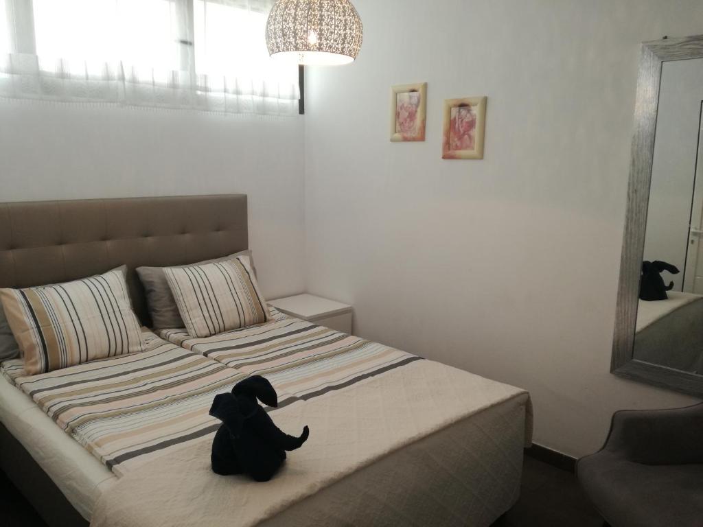 a black dog sitting on a bed in a bedroom at Modern Apartment in Playa del Ingles