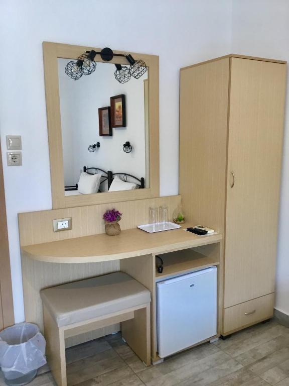a dressing room with a desk and a mirror at Platanos Rooms in Anopoli Sfakion