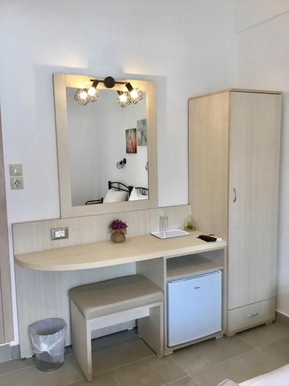 a bathroom with a dressing table and a mirror at Platanos Rooms in Anopoli Sfakion