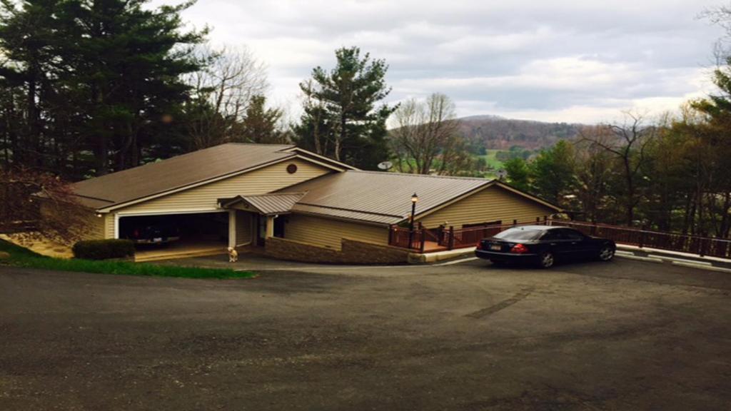 a house with a car parked in a parking lot at Heaven On Earth in Boone