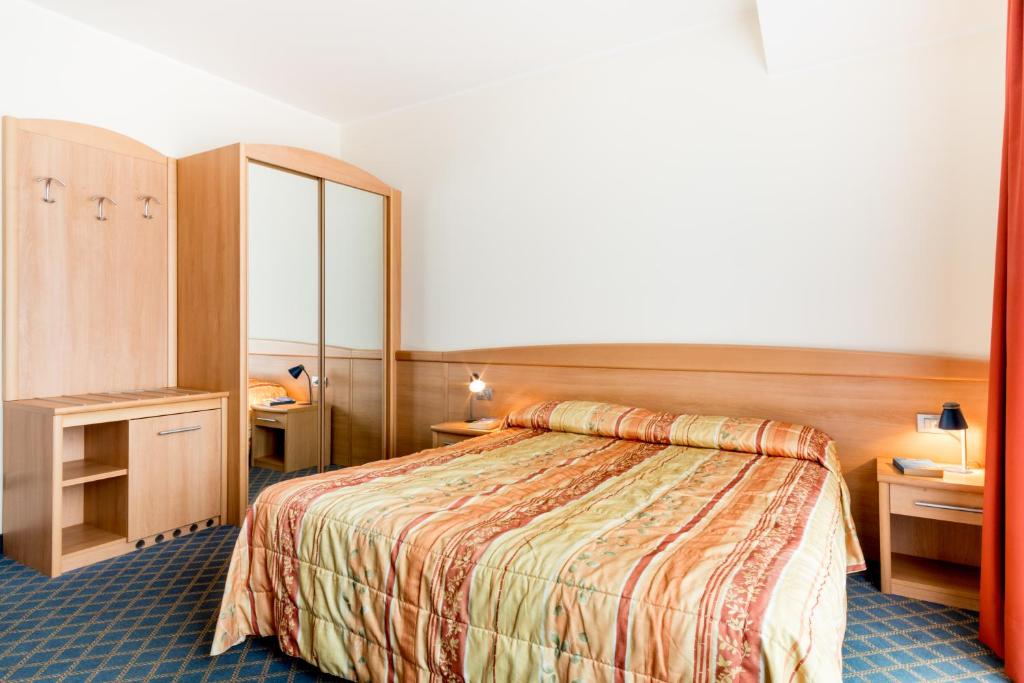 Postel nebo postele na pokoji v ubytování Hotel San Vito