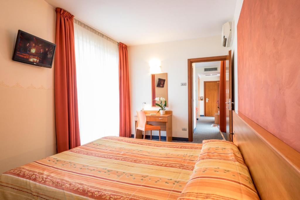 Postel nebo postele na pokoji v ubytování Hotel San Vito