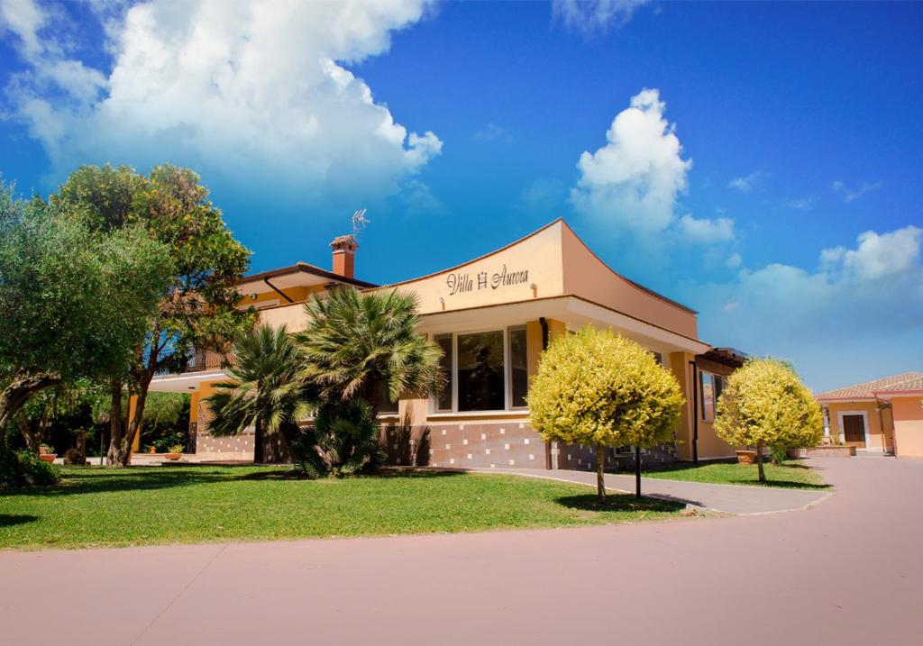 a building with trees in front of it at Hotel Villa Aurora in Latina