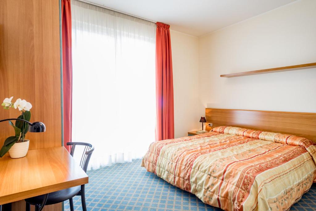 Postel nebo postele na pokoji v ubytování Hotel San Vito