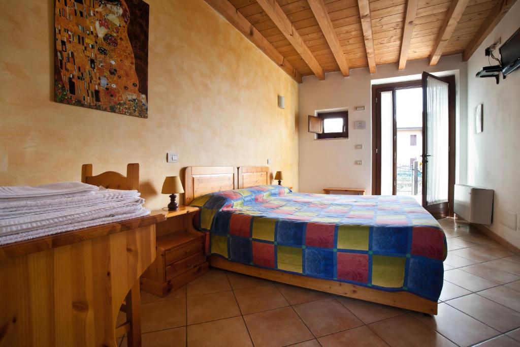Postel nebo postele na pokoji v ubytování Agriturismo Le Sigalette