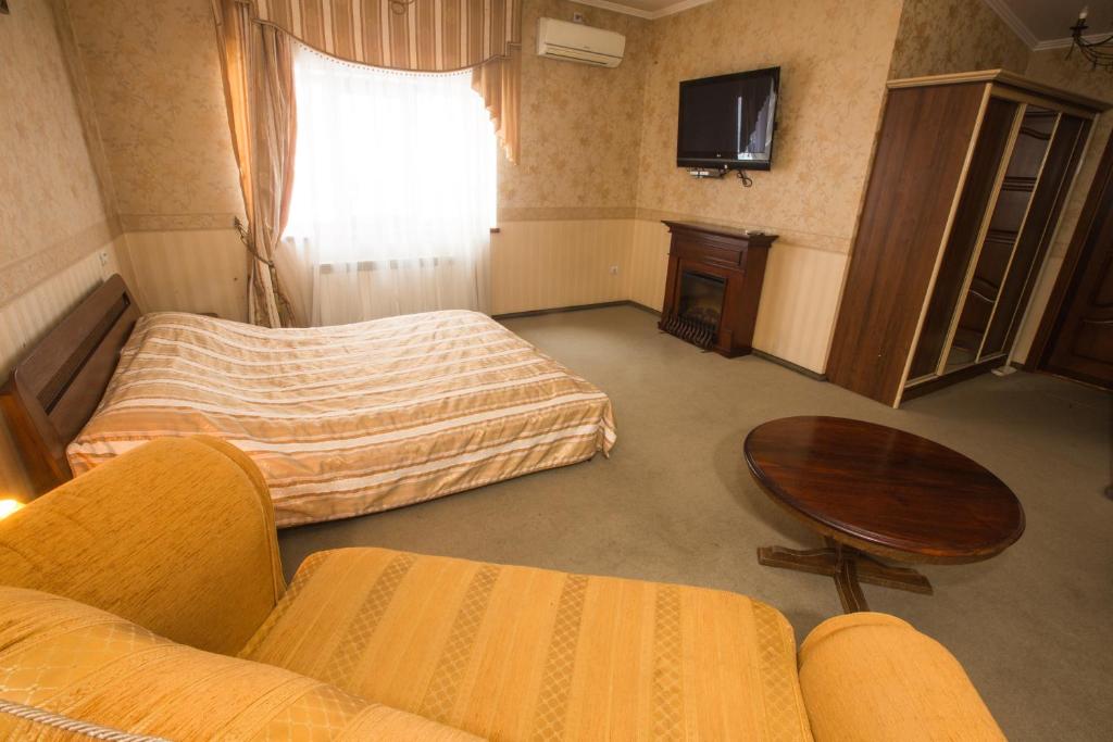 Postel nebo postele na pokoji v ubytování Magnat Lux Hotel