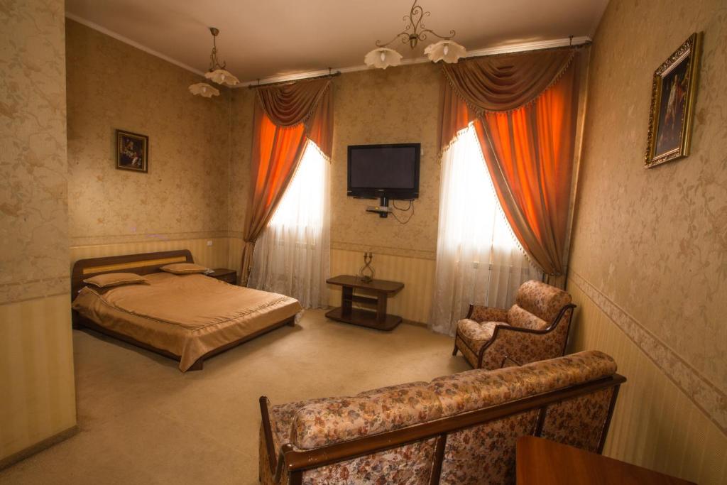 TV a/nebo společenská místnost v ubytování Magnat Lux Hotel