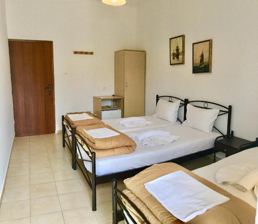 a room with two beds and two trunks at Platanos Rooms in Anopoli Sfakion