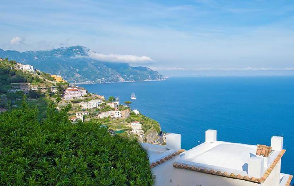 a view of the ocean from a house on a hill at L'Antico Borgo Dei Limoni in Amalfi