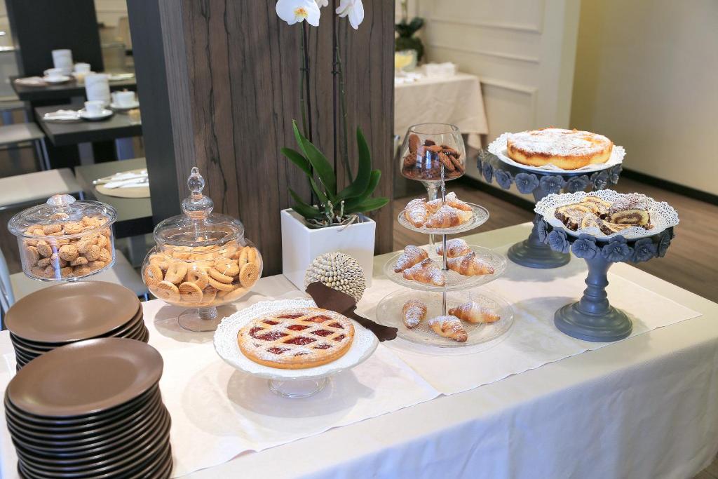 a table with various pastries and desserts on it at Hotel Carla in Levanto