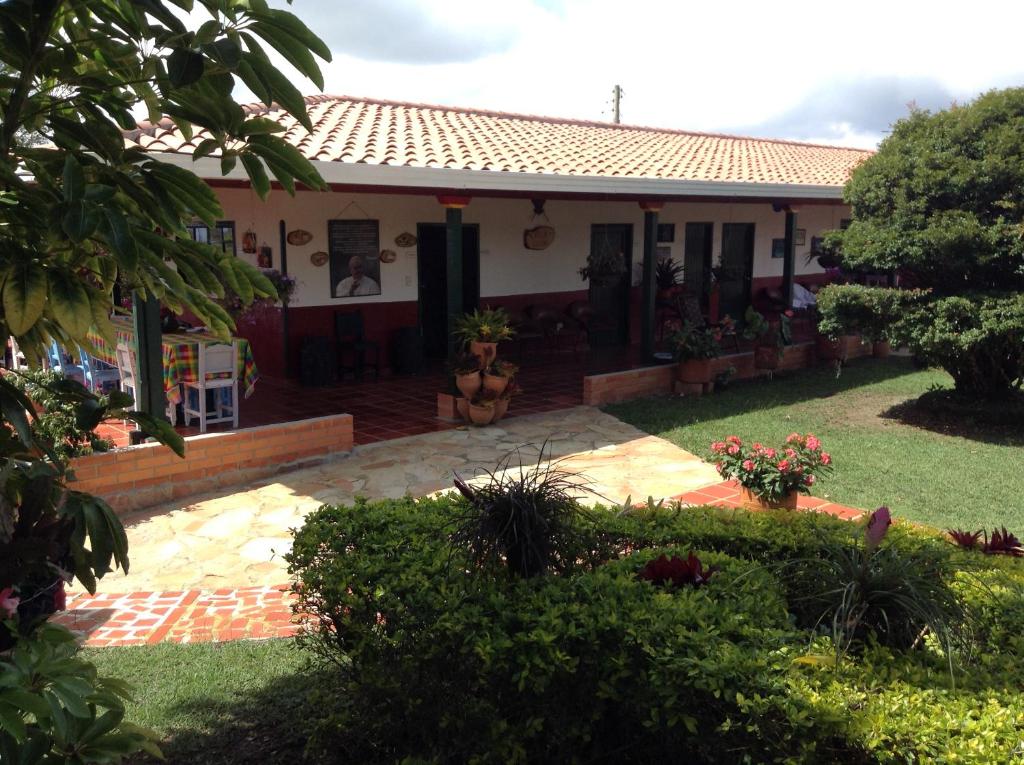 a house with a garden in front of it at Villa Liliana Lodge Mesa de los Santos in Los Santos