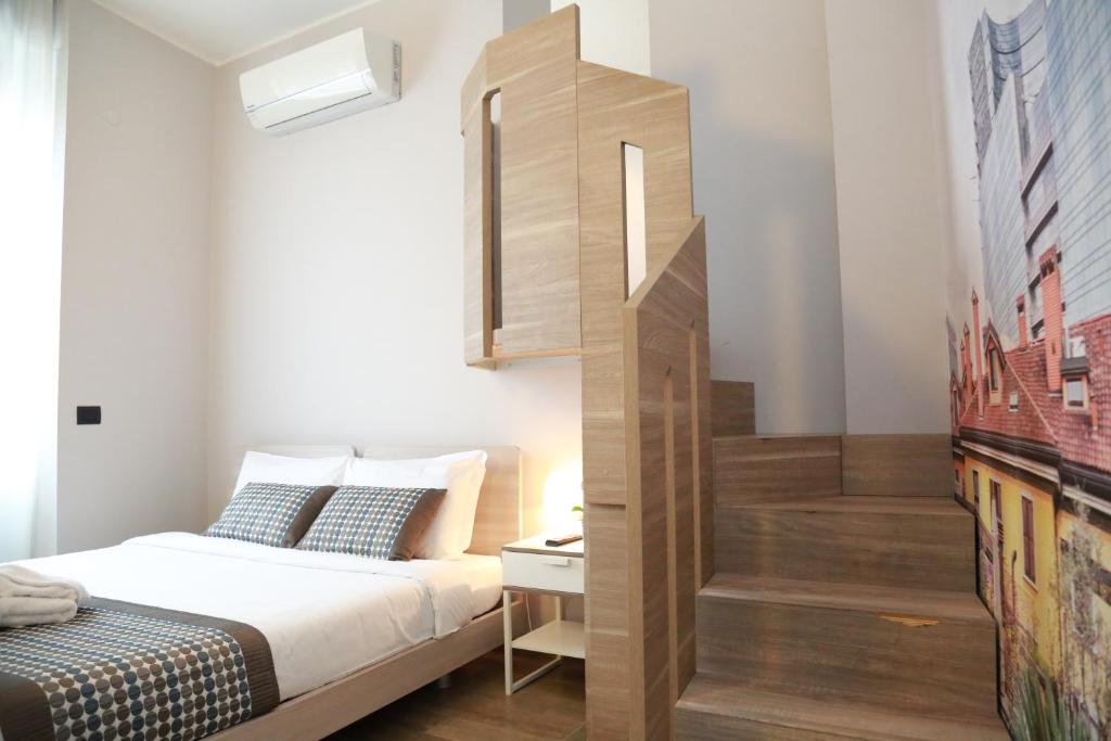 Postel nebo postele na pokoji v ubytování Aparthotel Meneghino