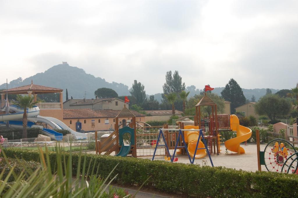 a park with a playground with a slide and a slideintend at Résidence Niccola in Vidauban