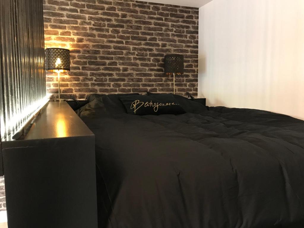 Postel nebo postele na pokoji v ubytování Coeur de ville