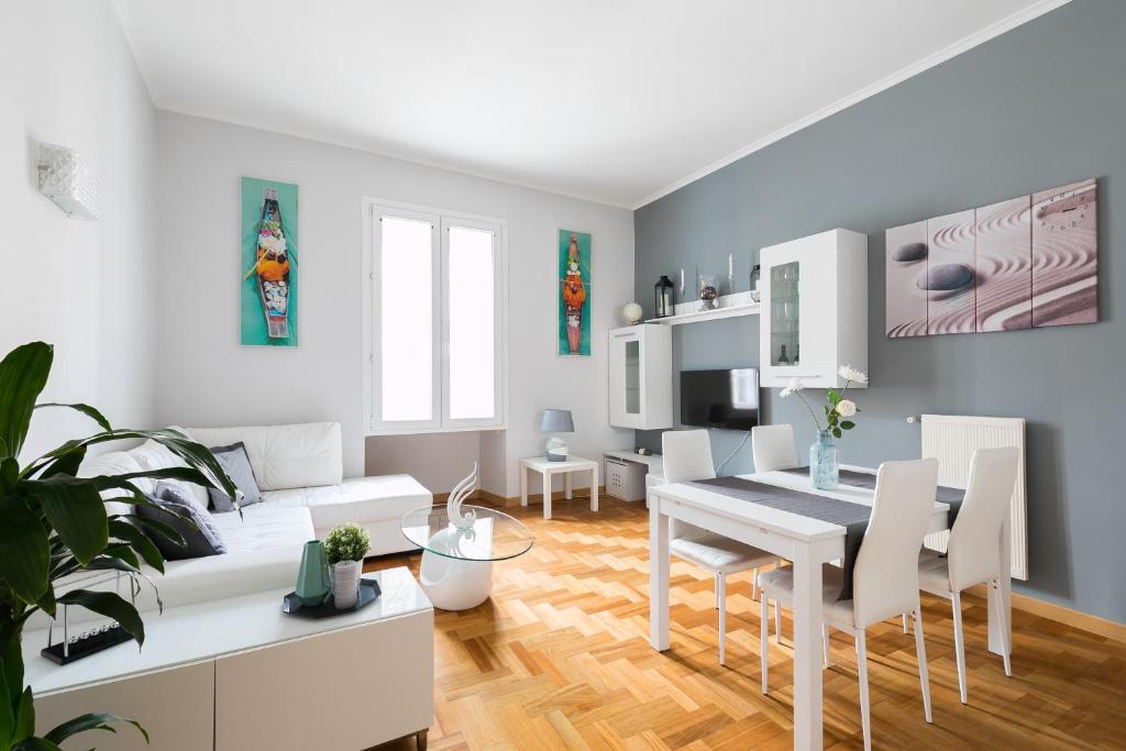 a living room with a table and a dining room at HomeHouse Giulio Cesare-San Pietro in Rome