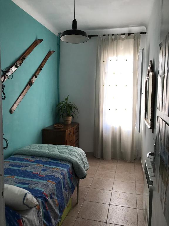 a bedroom with a bed and a window at Apartamento Rural situado en tercera planta sin ascensor in Navás