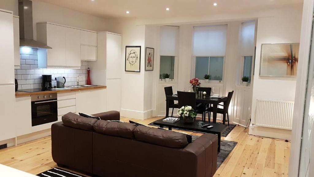 a living room with a couch and a table at Apartment at 5 Victoria Parade in Ramsgate