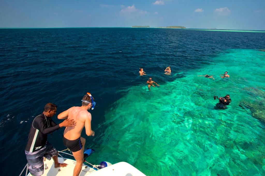 a group of people on a boat in the water at Kaani Beach Hotel in Maafushi