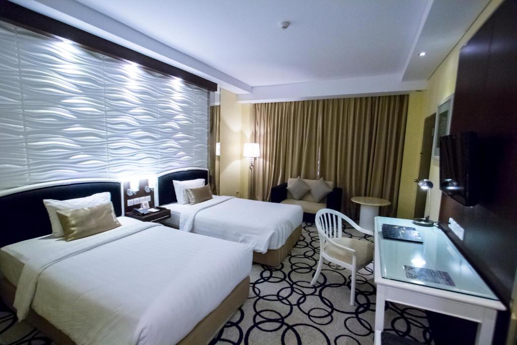Voodi või voodid majutusasutuse Hotel New Saphir Yogyakarta toas