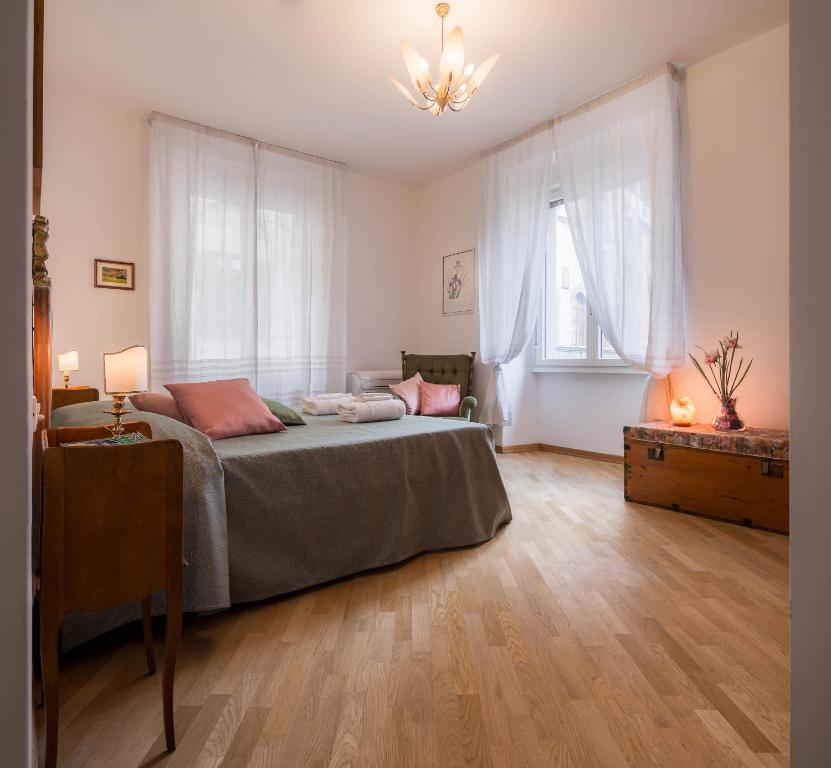a bedroom with a bed and a large window at Santa Felicita Apartments in Florence