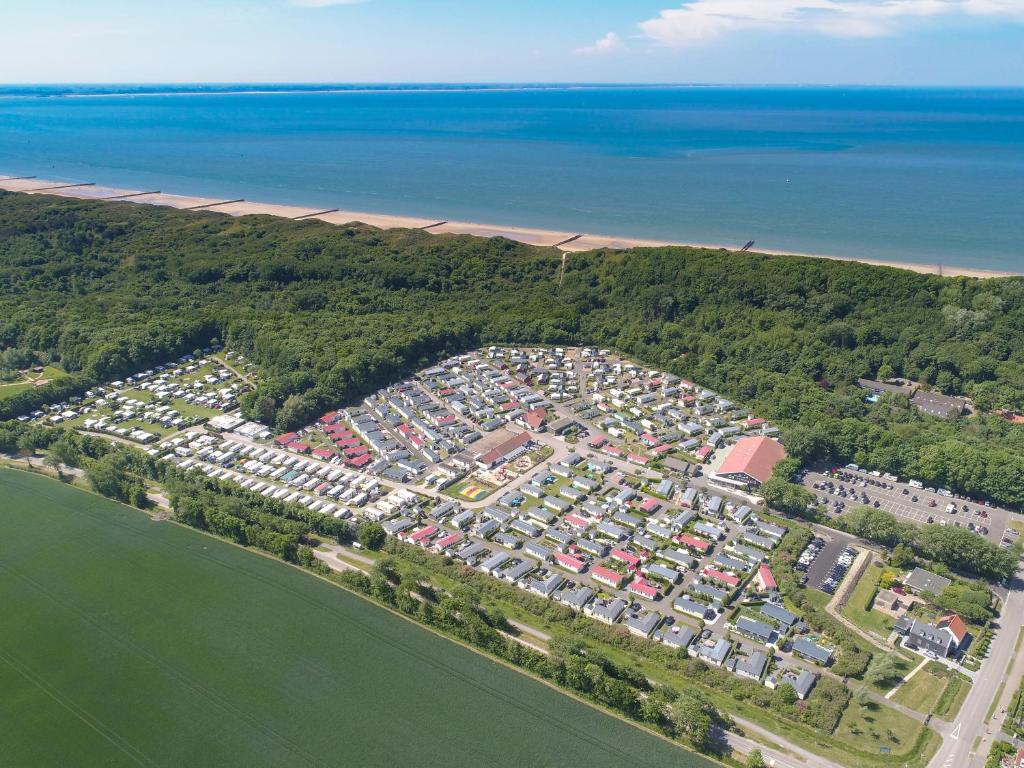 an aerial view of a parking lot next to the water at Strandcamping Valkenisse in Biggekerke