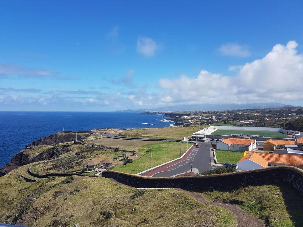 an aerial view of a road on a hill next to the ocean at Seaside Azores Villa with natural pool, terrace & barbecue in Capelas