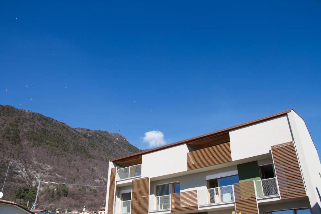 an apartment building with a mountain in the background at Ingrappa Sporthouse in Borso del Grappa