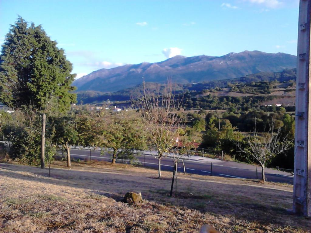 a train traveling down a road with mountains in the background at Casa Rural La Venta Sales in Sales