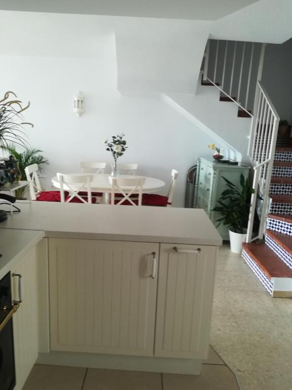 a kitchen with a table and a dining room at Casa Las Toro Playa in Chilches