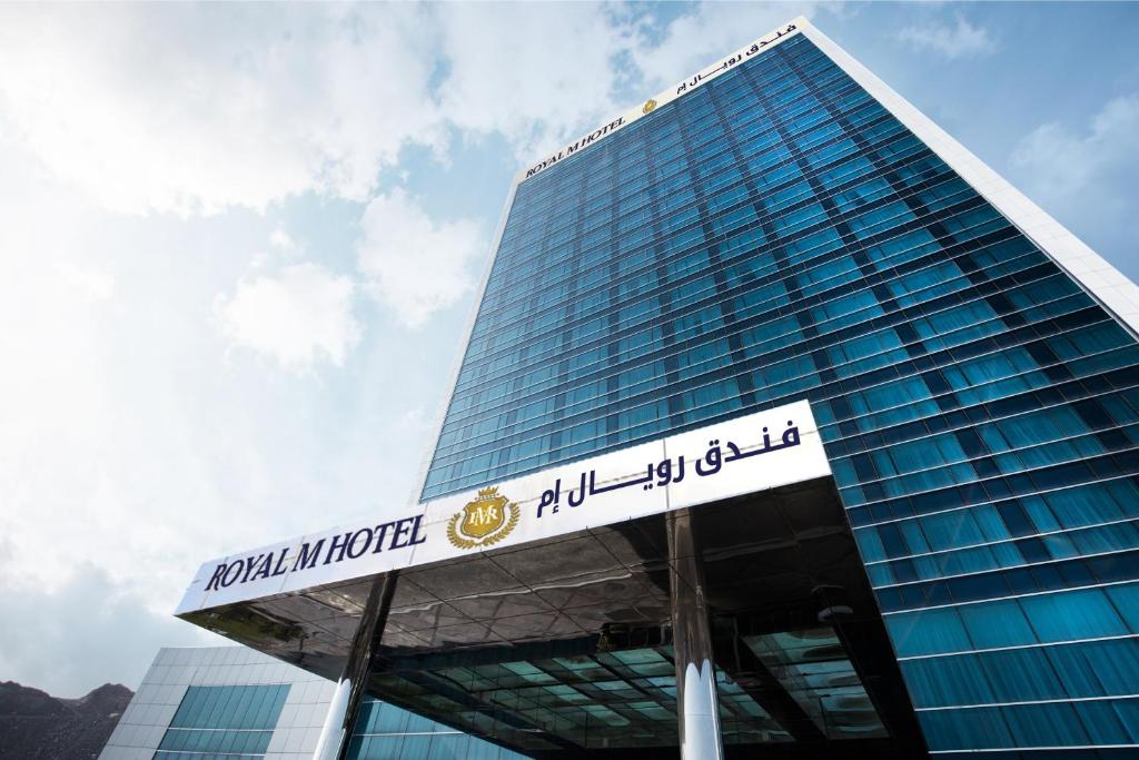 a tall building with a sign in front of it at Royal M Hotel Fujairah by Gewan in Fujairah