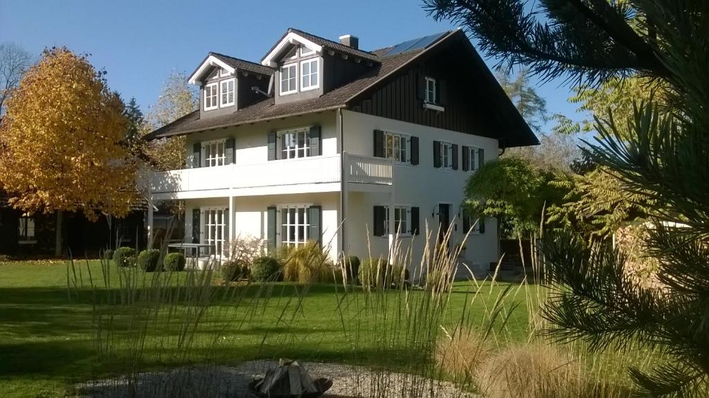 a large white house with a black roof at Apartment Schreyegg in Seefeld