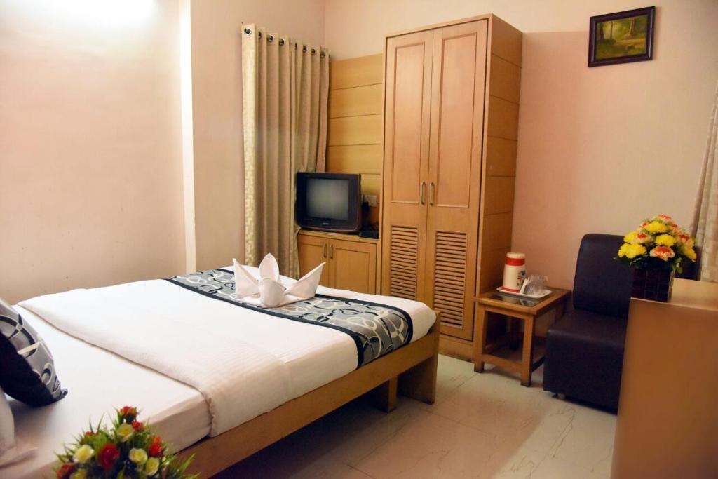 Postel nebo postele na pokoji v ubytování Samudra Residency
